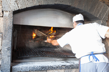 Cook lighting the grill