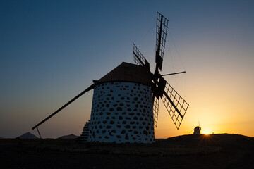 Old flour mill with a very colorful sunset background