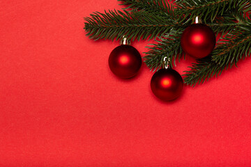 Fototapeta na wymiar Red Christmas balls with Christmas tree on red background. Flat lay, top view, copy space. Christmas banner