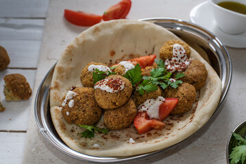 falafel in pita bread with tomato and parsley and yogurt sauce 