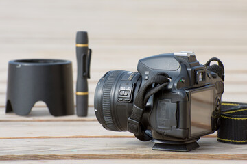 Digital camera and accessories on a solid light background.