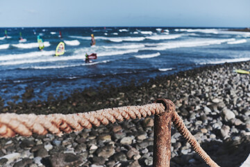 Rope At A Boardwalk in front of the rocky beach