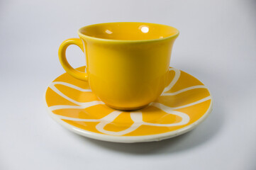 Cup of coffee or tea. Yellow and white background
