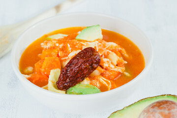 Traditional caldo tlalpeño close-up on white colors