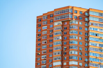 Fototapeta premium Brick building with windows on sky background
