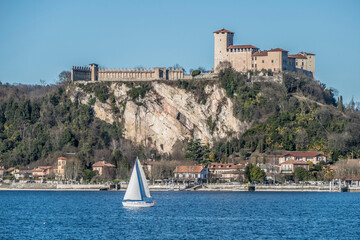 Landscape of the castle of Angera and the city with a boat that is sailing