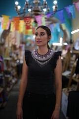Portraits of a charming red-haired girl with a cute face. Girl posing for the camera in the city center. She has a wonderful mood and a lovely smile, mexican lifestyle