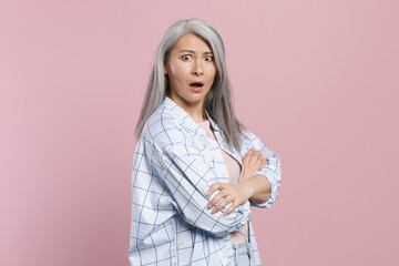 Side view of shocked worried nervous gray-haired asian woman wearing basic white checkered shirt...