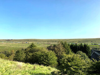 Fototapeta na wymiar Landscape view, looking from, Pike End Road, toward the M62 motorway, on a hot summers day near, Ripponden, Halifax, UK
