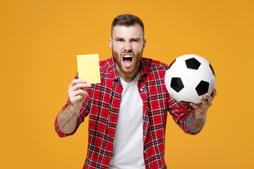 Angry young man football fan in red shirt cheer up support favorite team with soccer ball propose...