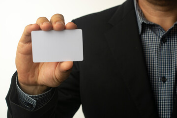A businessman is holding a white business card.