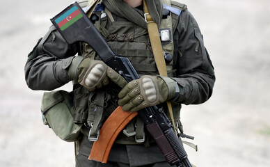 Flag of Azerbaijan on submachine gun butt. Military Conflict in the Caucasus. Collage.