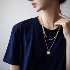 Poster Closeup photo of yping woman wearing dark t-shirt and golden necklace © cherry_d