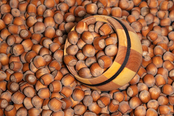 Filtered image of Hazelnuts in a wooden bowl
