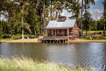 Scenic view of the front exterior of a rural rustic wooden camp house used for rental, cabin,...