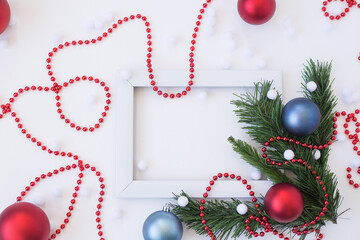 new year's white frame with fir branches and Christmas balls on a white background