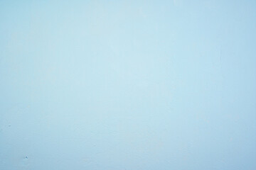Pale blue concrete background with visible texture, top view. Concept for your design.