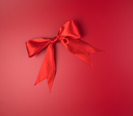 Large red bow on a red background. Romantic background. Greeting card concept.