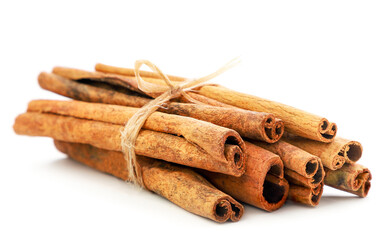 Cinnamon sticks tied with rope on a white background. Isolated