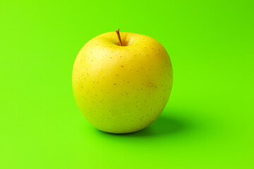 yellow Apple on a green background close-up.isolate