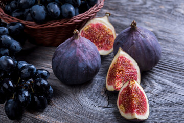 Fresh figs and grapes on rustic wooden  background