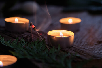 Incense stick and candles on rustic wood