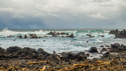 Beautiful shore. Large boulder among the waves in the sea. Hawaii