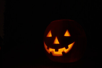 Halloween pumpkin smile and scary eyes for party night. Close up view of scary Halloween pumpkin...