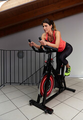 woman spinning at home exercising for their legs and cardio training