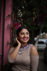 Fototapeta na wymiar young pretty mexican woman smiling happy, lifestyle people concept, mexican neckless, street art
