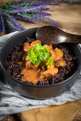 Thai red curry with chicken and black rice.