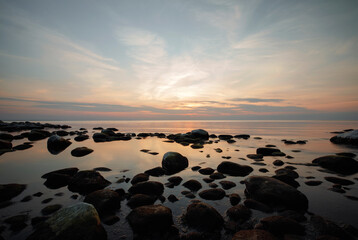 Fototapeta na wymiar Finnish gulf with stones at sunset