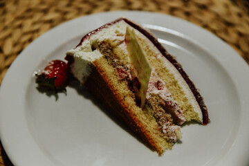 piece of cake with chocolate. natural strawberry cake with cream and chocolate