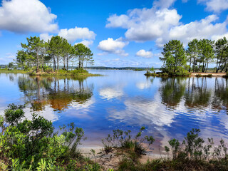 water reflection in blue summer sky at Lacanau lake in France