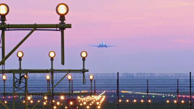 An airplane taking off from Rotterdam The Hague Airport, The Netherlands by sunset.