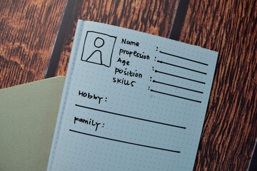 User's Persona write on a book isolated on wooden table.