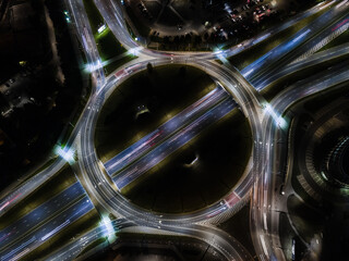 Elevated road junction with roundabout and interchange overpass at night from above. Long exposure in Vilnius Lithuania © Mantas