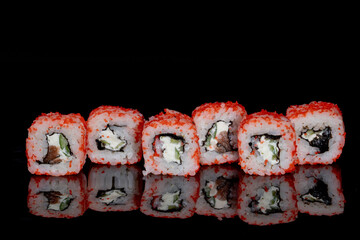 Philadelphia roll with salmon, cheese and cucumber on a black background with reflection. Sushi Philadelphia