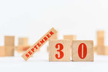 30th of September on the wooden calendar blocks on white background.