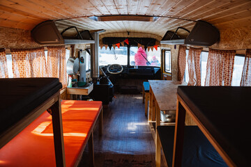 bus in the forest equipped with sleeping places with a stove. the interior of the hut, beds in two tiers in a hut in the woods. hunter's home. a tourist shelter.
