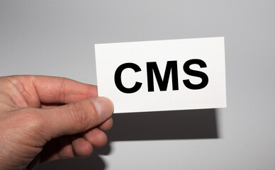 Message on the card CMS, in hands of businessman.