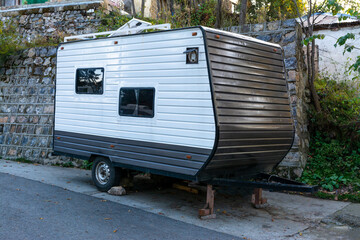 A camper trailer parked alongside a road on a hill station tourists spot