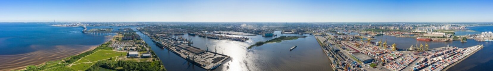Fototapeta premium Aerial view of cargo ship, cargo container in warehouse harbor in the Morskie Vorota district in St. Petersburg