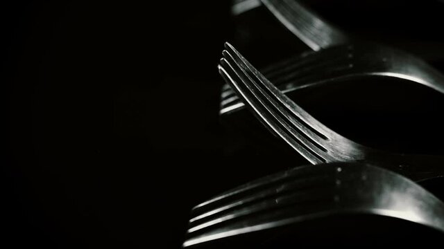 Composition made of forks on the black background.