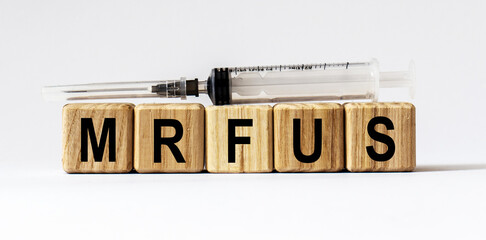 Text MRFUS made from wooden cubes. White background