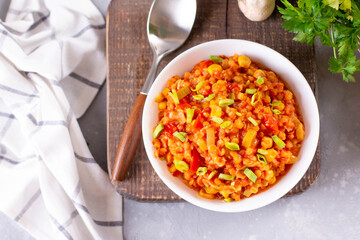 Homemade vegan lentil soup with vegetables, light background, top view, copy space. Indian vegetarian cuisine.