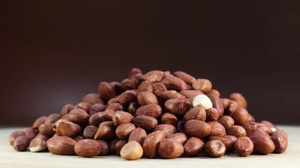 Heap of raw peanuts. Cultivated peanuts, underground or groundnuts. Plant of the legume family. Agricultural crop on an industrial scale. South America is considered the birthplace of peanuts.