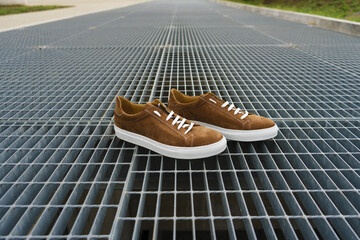Brown men's shoes with industrial background