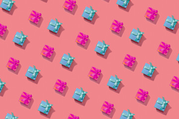 Open composition of blue and red Christmas gift boxes on pink in diagonal. New Year concept.