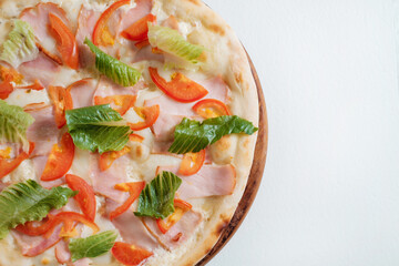 Italian pizza with ham cheese salad and tomatoes on white background.